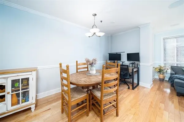 a view of a dining room with furniture wooden floor and chandelier
