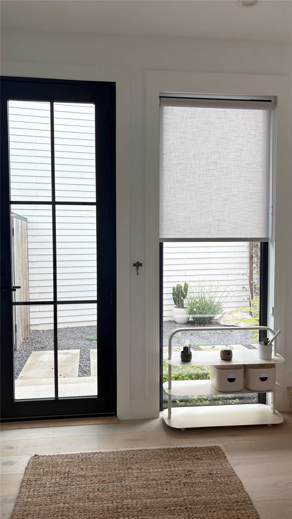 1816 Adina Street, Unit 2 Austin, TX 78721 - Photo 2 of 25 Black-framed glass-paneled door with light wood-finish flooring