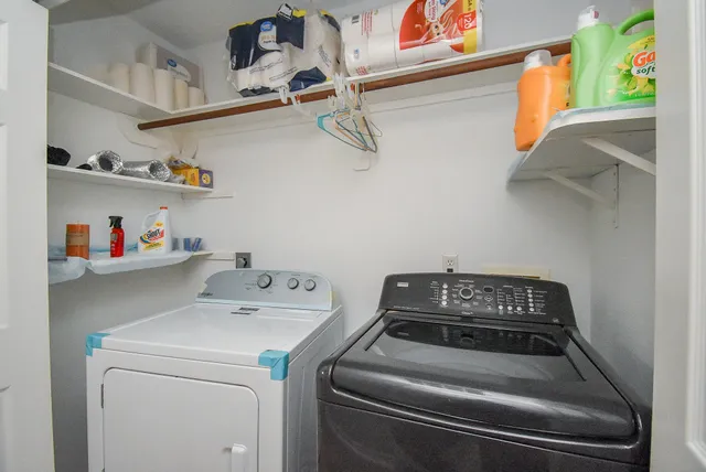 a front view of a house with a garden and trees