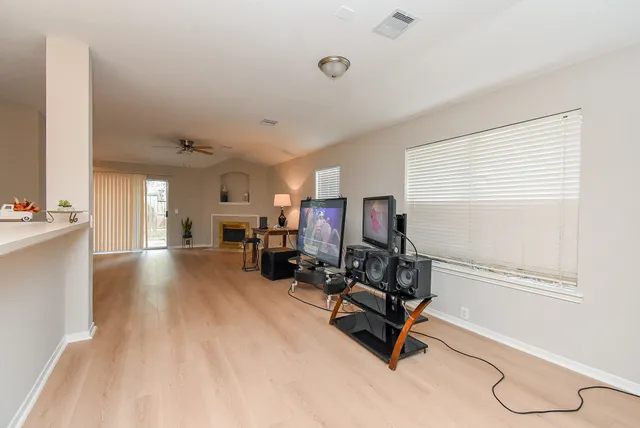a view of a livingroom with workspace and a window