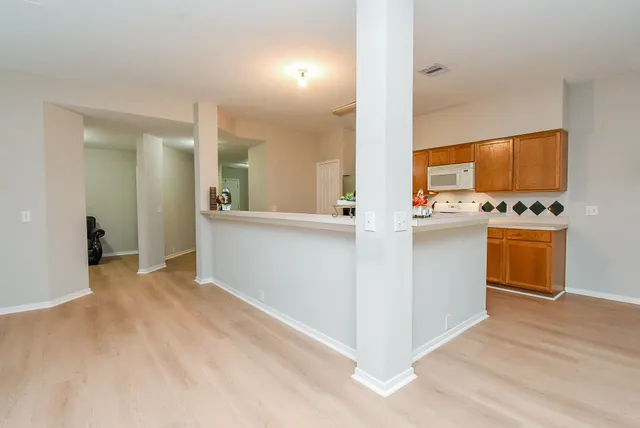 a view of a kitchen with a sink and a stove top oven