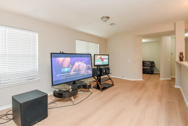 a room with furniture and a flat screen tv