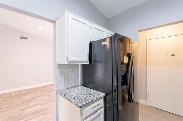 a kitchen with stainless steel appliances granite countertop a refrigerator and a sink