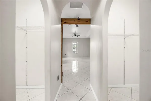 a hallway with sliding door and front door