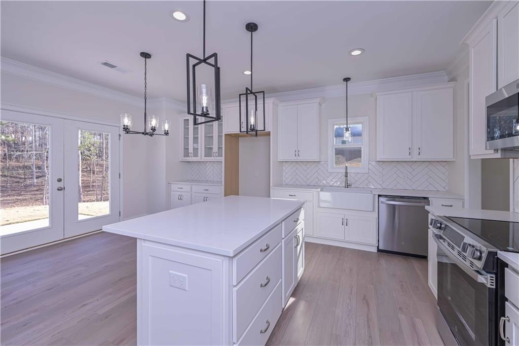 262 Corinth-Five Points Road Buchanan, GA 30113 - Photo 12 of 41 a kitchen that has a lot of cabinets in it and wooden floors