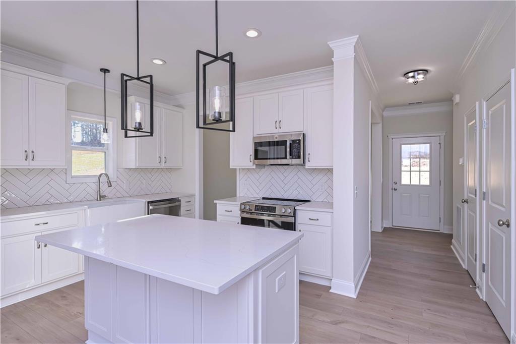 262 Corinth-Five Points Road Buchanan, GA 30113 - Photo 13 of 41 a kitchen with stainless steel appliances a stove a sink a refrigerator a center island and cabinets
