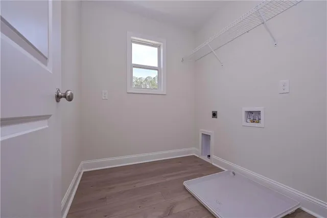 a view of a room with wooden floor and window