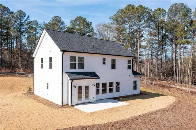a view of a white house with a yard
