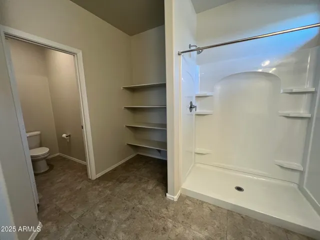 a bathroom with a shower and a toilet