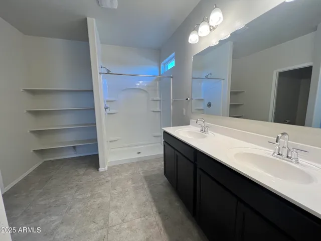 a bathroom with a double vanity sink a and a mirror