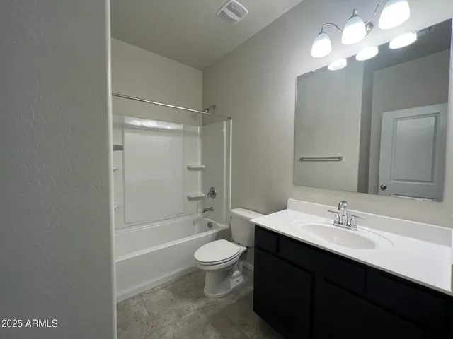 a bathroom with a double vanity sink toilet and shower