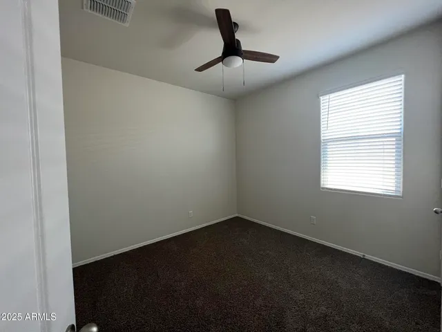 a view of room with a ceiling fan and window