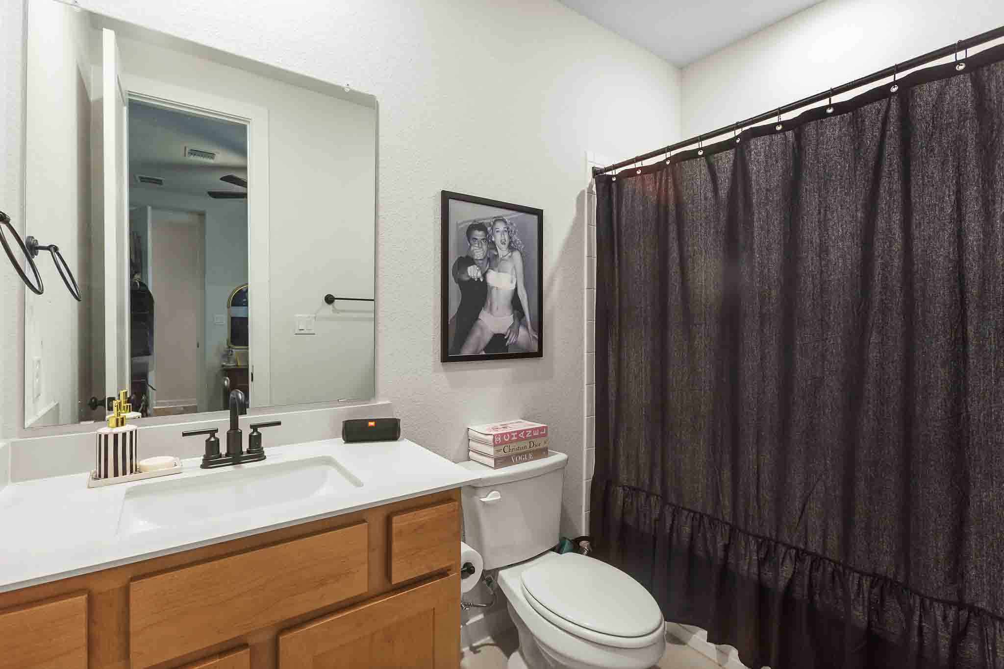 220 Basket Flower Loop Kyle, TX 78640 - Photo 23 of 40 A well-appointed bathroom features a single vanity with ample counter space and a modern toilet.
