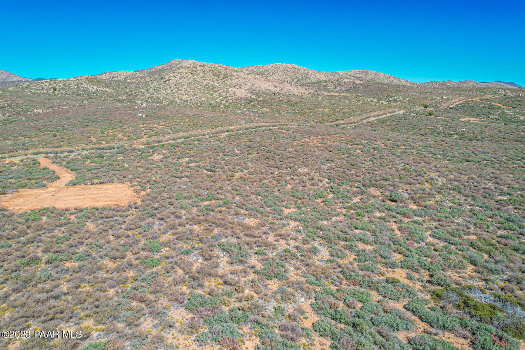 a view of a large mountain with mountains in the background