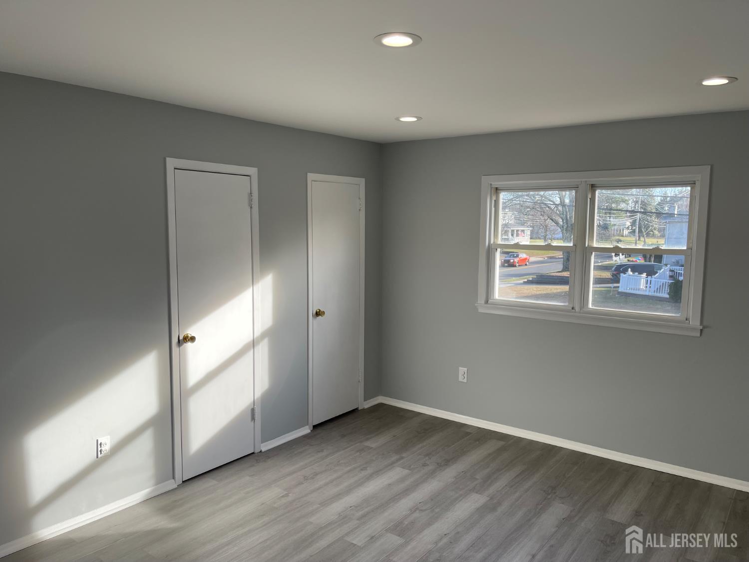 57 Greenbrook Road Middlesex, NJ 08846 - Photo 12 of 18 an empty room with wooden floor and windows