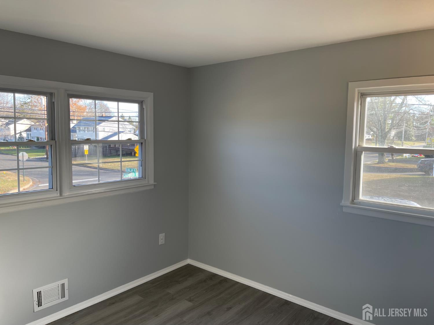 57 Greenbrook Road Middlesex, NJ 08846 - Photo 13 of 18 an empty room with wooden floor and windows