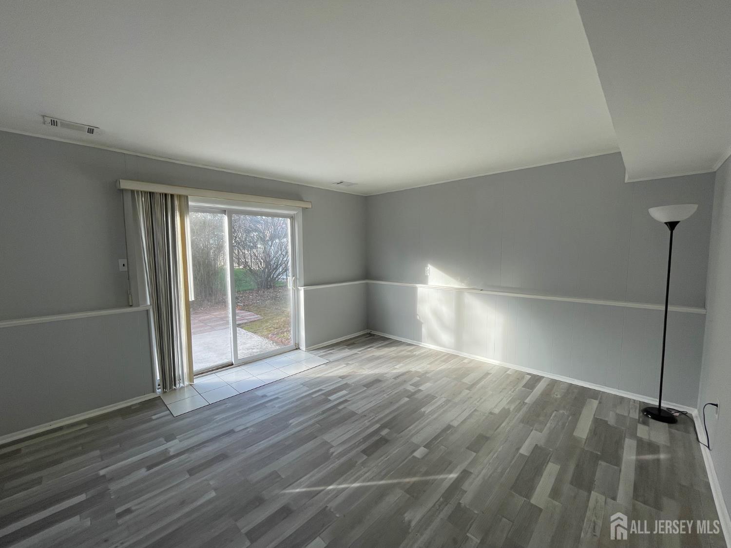 57 Greenbrook Road Middlesex, NJ 08846 - Photo 5 of 18 an empty room with wooden floor and windows