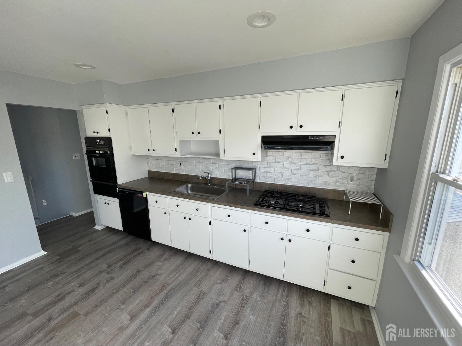 57 Greenbrook Road Middlesex, NJ 08846 - Photo 7 of 18 a kitchen with granite countertop a sink a stove a refrigerator and cabinets