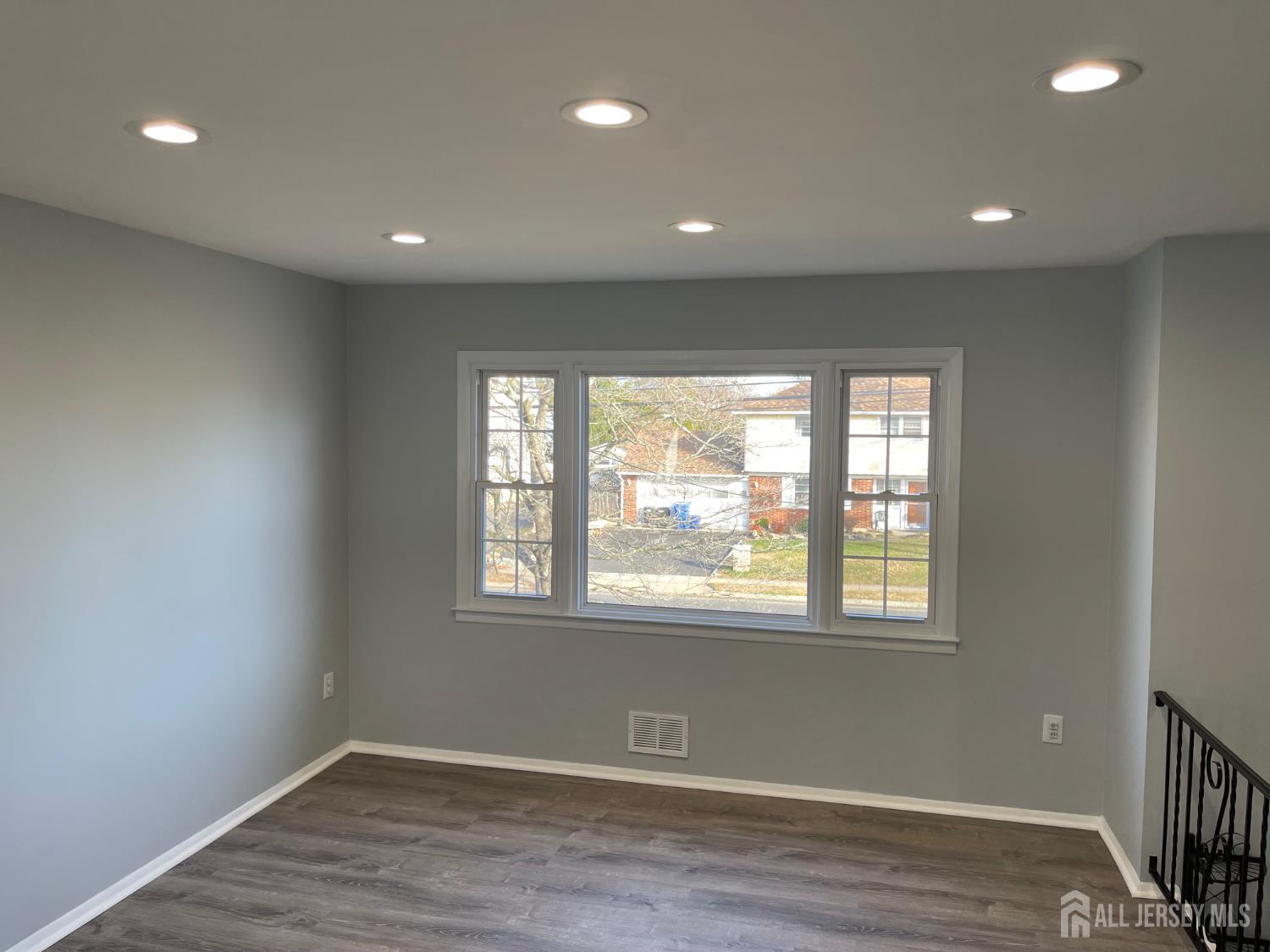 57 Greenbrook Road Middlesex, NJ 08846 - Photo 9 of 18 a view of an empty room with wooden floor and a window