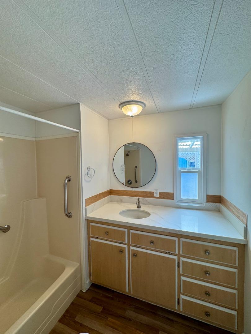 12350 Christensen Road, Unit 76 Salinas, CA 93907 - Photo 13 of 19 a bathroom with a sink mirror toilet and bathtub