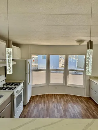 a kitchen with stainless steel appliances granite countertop a stove and a refrigerator