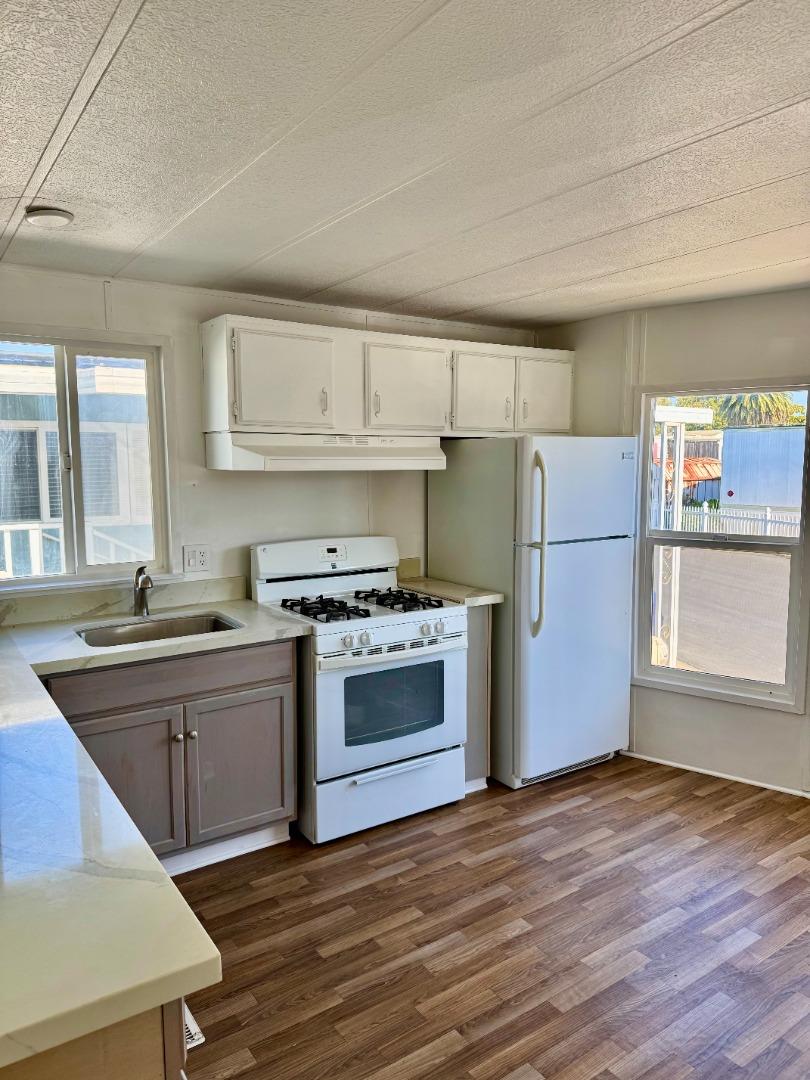 12350 Christensen Road, Unit 76 Salinas, CA 93907 - Photo 5 of 19 a kitchen with a refrigerator and a sink