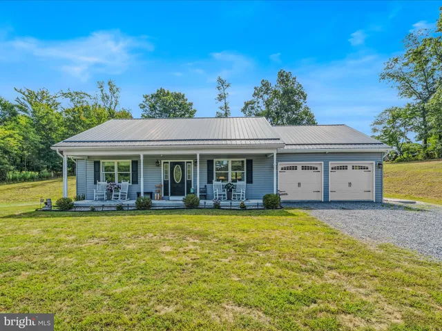 a view of a house with swimming pool and a yard