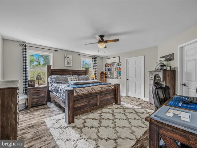 a bedroom with a bed and a flat tv screen on the dresser