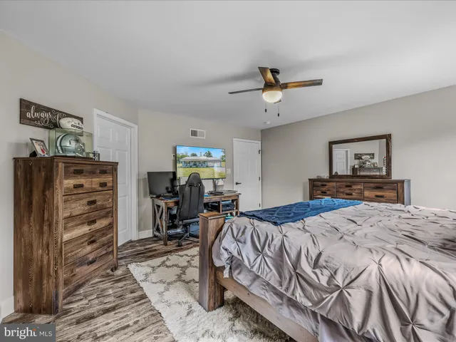 a bedroom with a bed dresser and a window