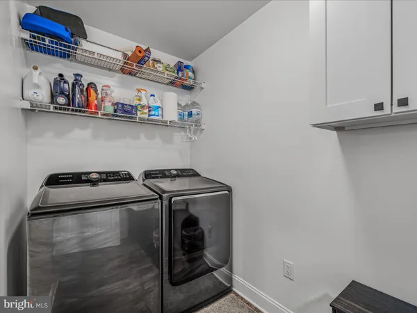 a close up of a utility room with washer and dryer