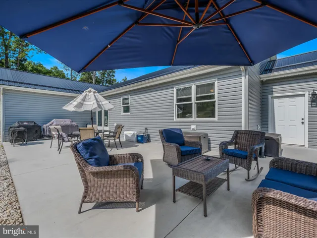 a patio with couches and a umbrella