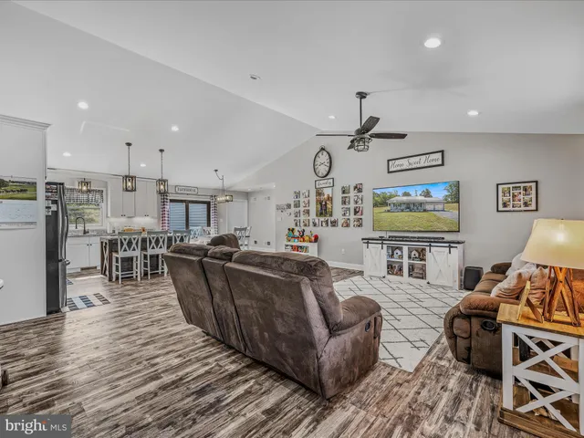 a living room with furniture and kitchen view