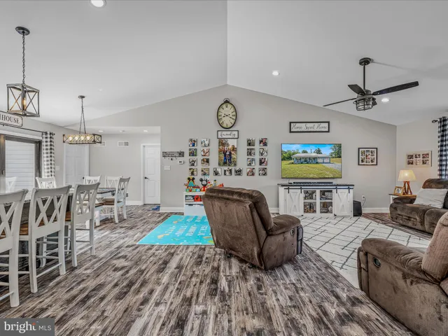 a living room with furniture and a clock