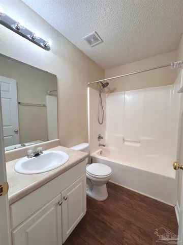 a bathroom with a double vanity sink toilet mirror and bathtub
