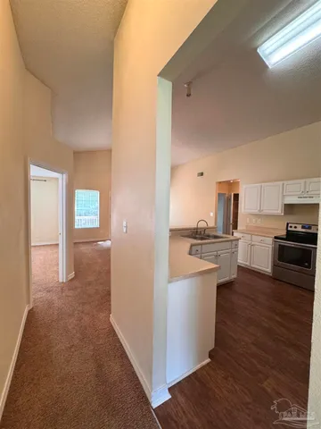 a view of kitchen with sink and wooden floor