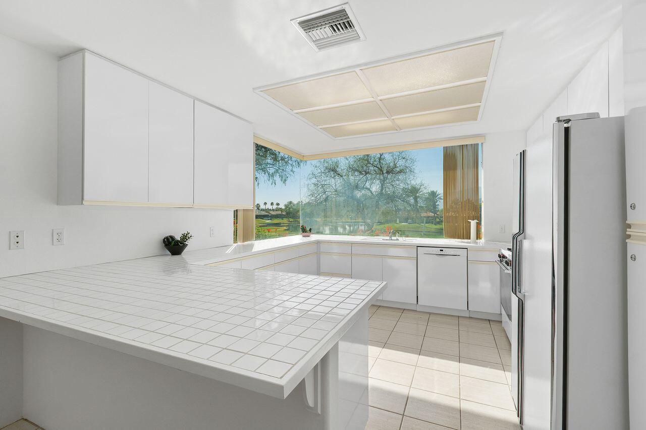 31 Pebble Beach Drive Rancho Mirage, CA 92270 - Photo 13 of 49 a kitchen with a sink a counter top space and appliances