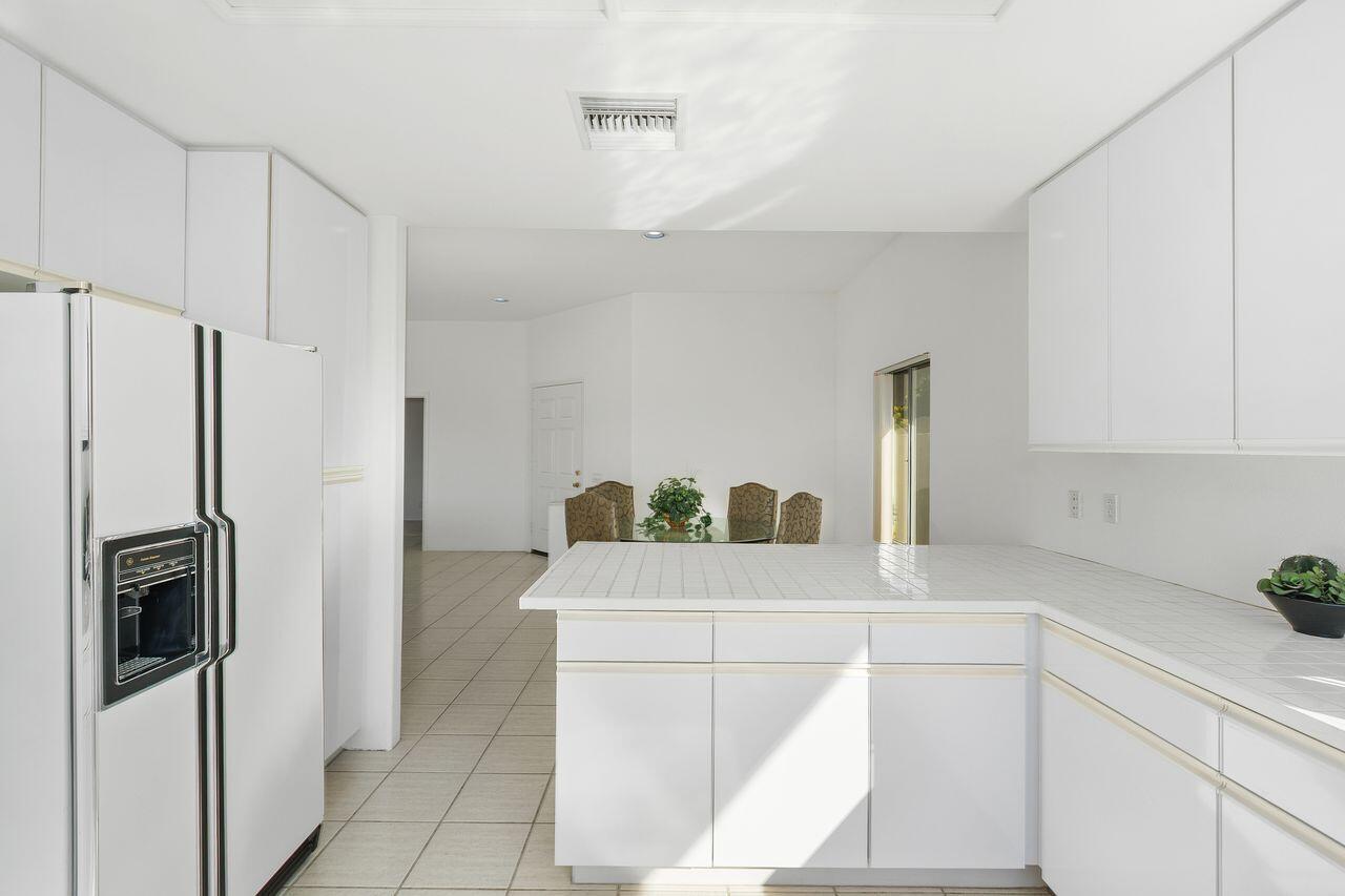 31 Pebble Beach Drive Rancho Mirage, CA 92270 - Photo 16 of 49 a kitchen with a refrigerator and a sink