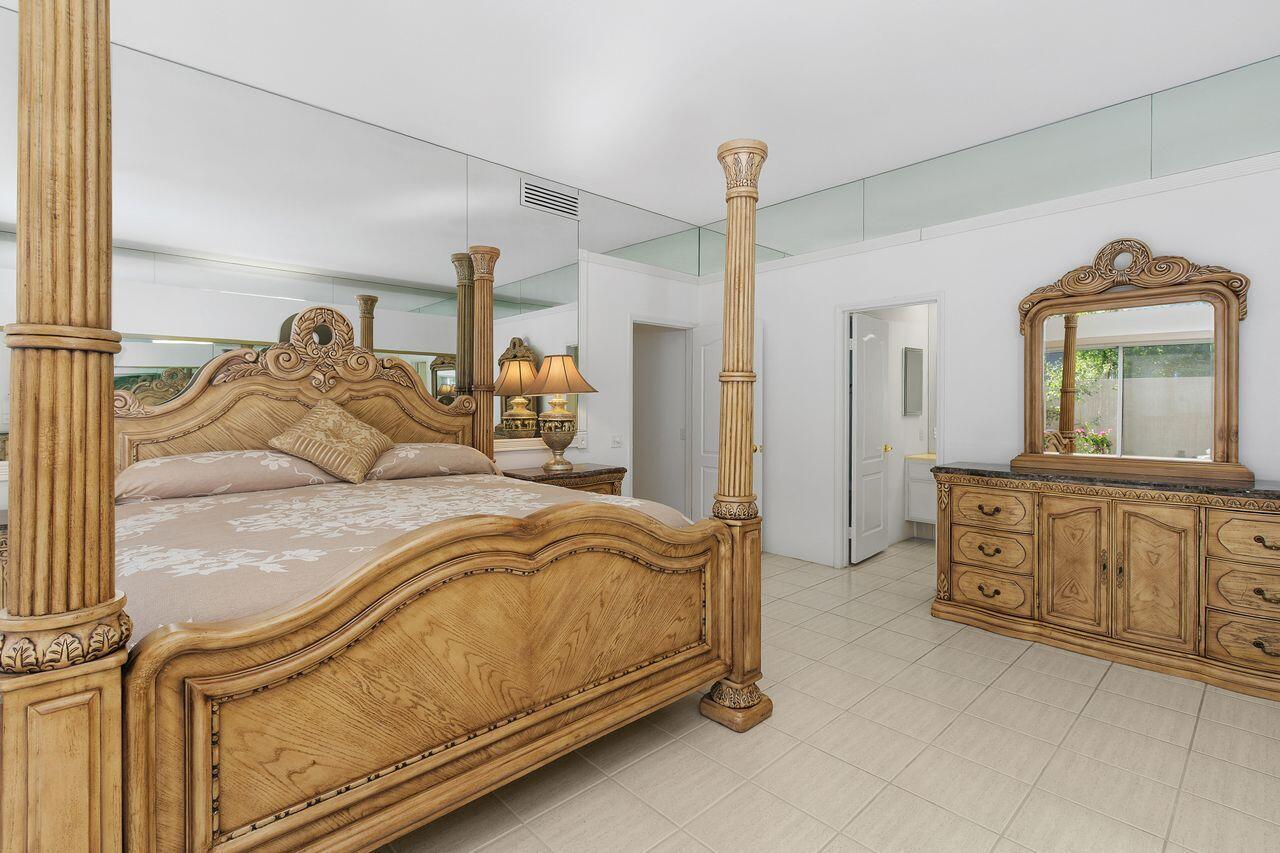 31 Pebble Beach Drive Rancho Mirage, CA 92270 - Photo 19 of 49 a bedroom with a bed and a dresser