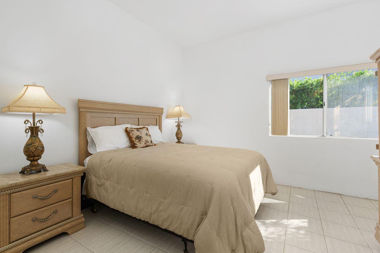 31 Pebble Beach Drive Rancho Mirage, CA 92270 - Photo 22 of 49 a bedroom with a bed and a window