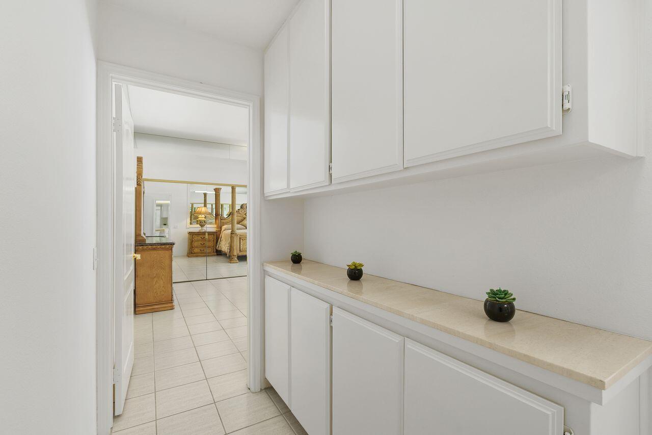 31 Pebble Beach Drive Rancho Mirage, CA 92270 - Photo 27 of 49 a kitchen with a sink and cabinets