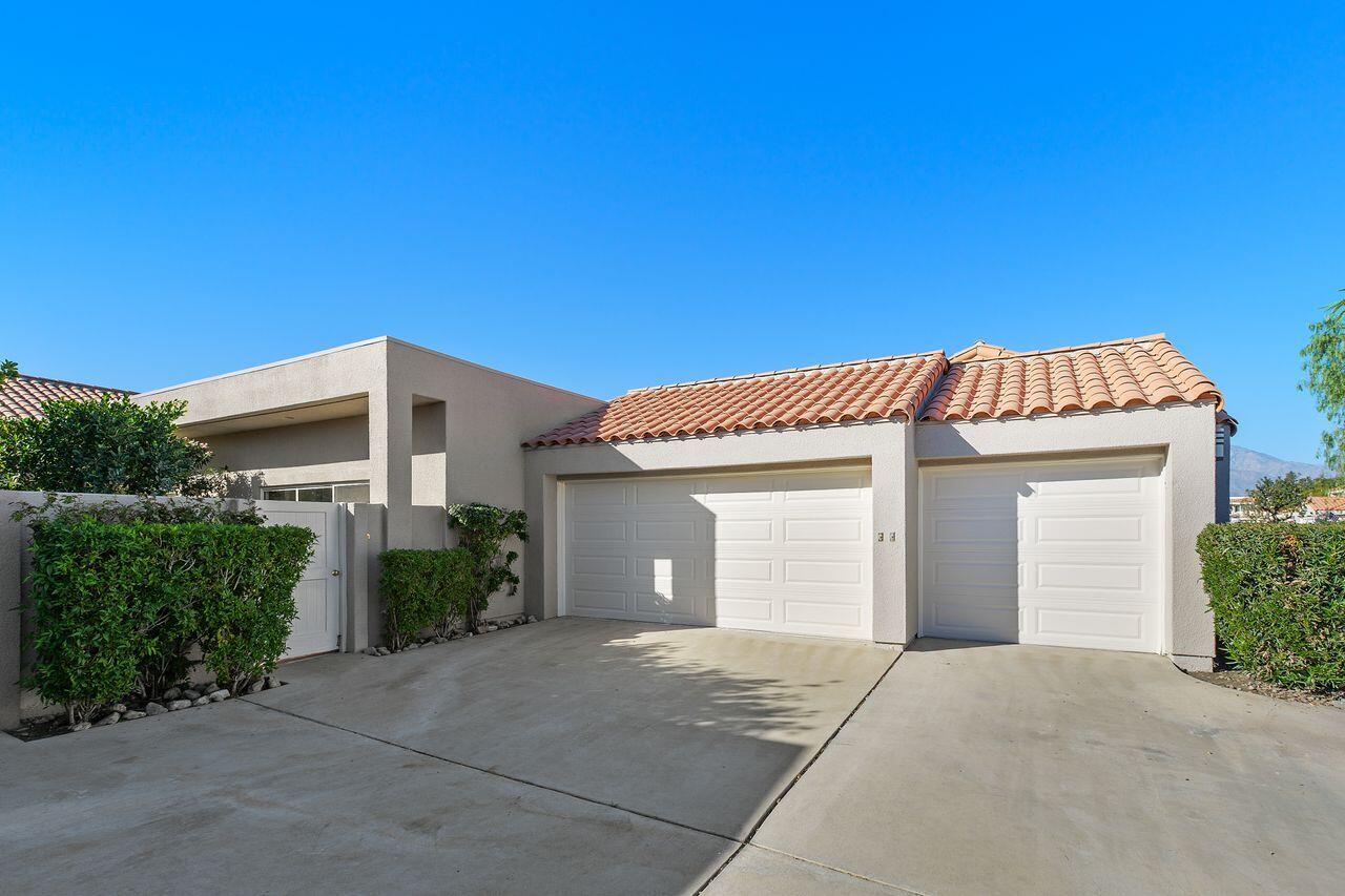 31 Pebble Beach Drive Rancho Mirage, CA 92270 - Photo 29 of 49 a front view of a house with a yard and garage