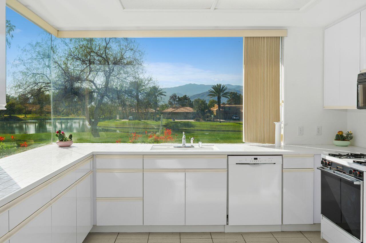 31 Pebble Beach Drive Rancho Mirage, CA 92270 - Photo 3 of 49 a kitchen with a sink and cabinets