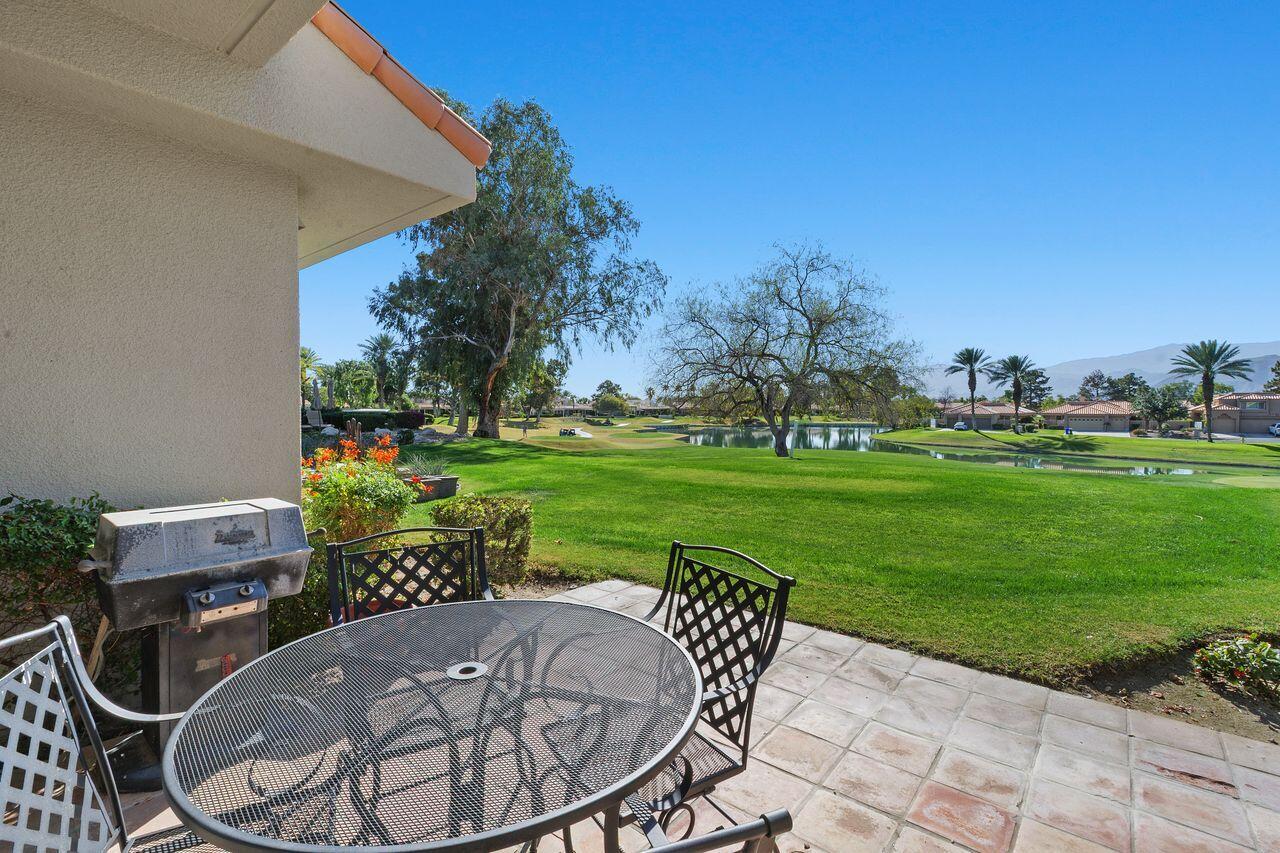 31 Pebble Beach Drive Rancho Mirage, CA 92270 - Photo 5 of 49 a patio with table and chairs and potted plants