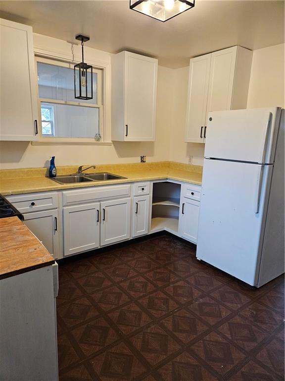 214 South Eberhart Road Butler, PA 16001 - Photo 6 of 27 a kitchen with cabinets a sink and a refrigerator