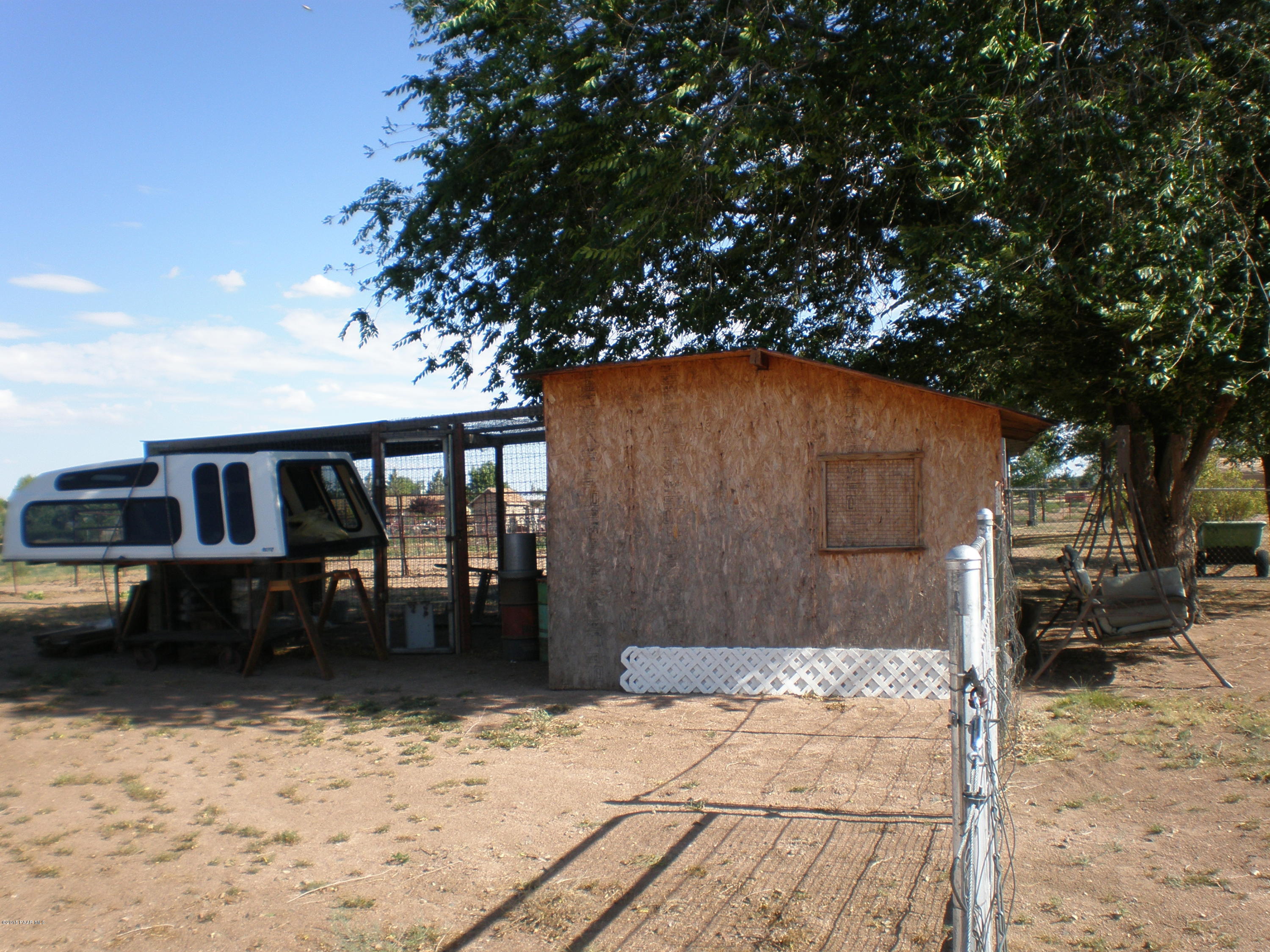 2885 North Reed Road Chino Valley, AZ 86323 - Photo 36 of 38 a backyard of a house with barbeque oven table and chairs