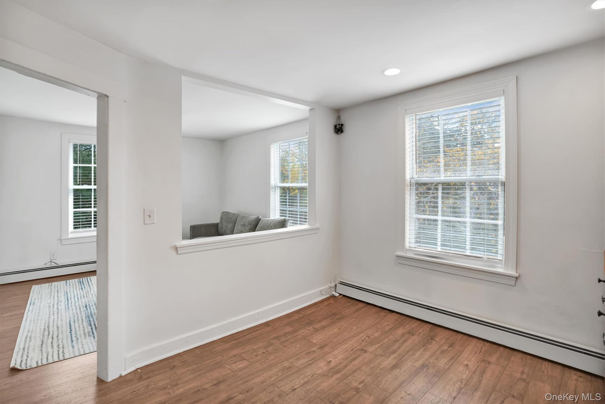 14 Halsey Avenue East Quogue, NY 11942 - Photo 12 of 23 an empty room with wooden floor and windows