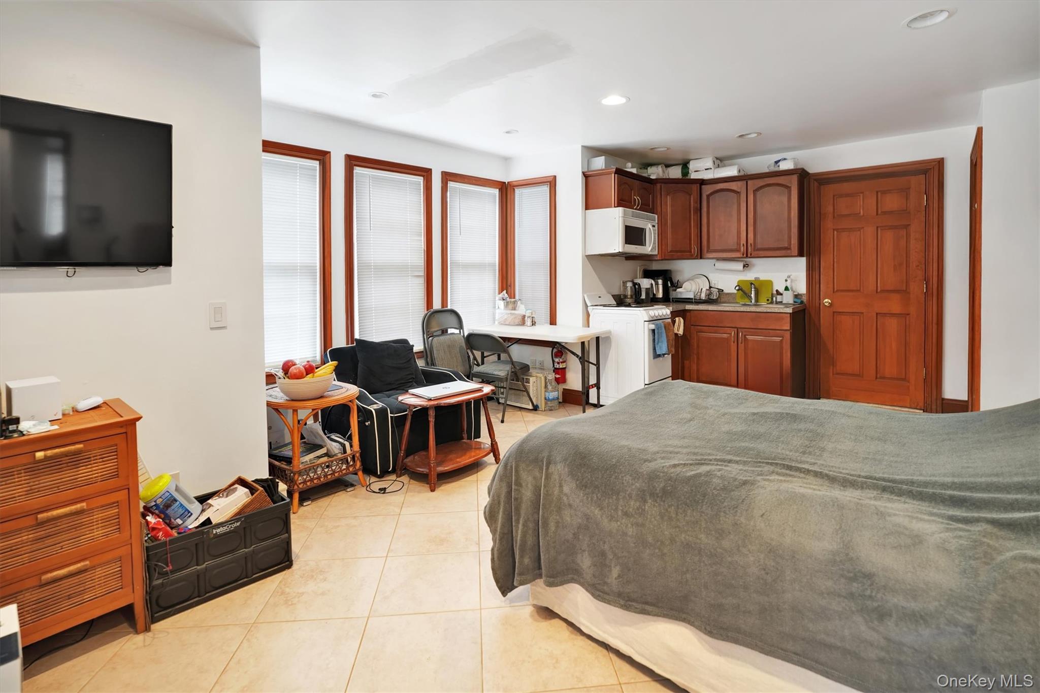 14 Halsey Avenue East Quogue, NY 11942 - Photo 18 of 23 a bed room with furniture and a flat screen tv