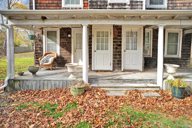 a view of a brick building with a bench in front of house