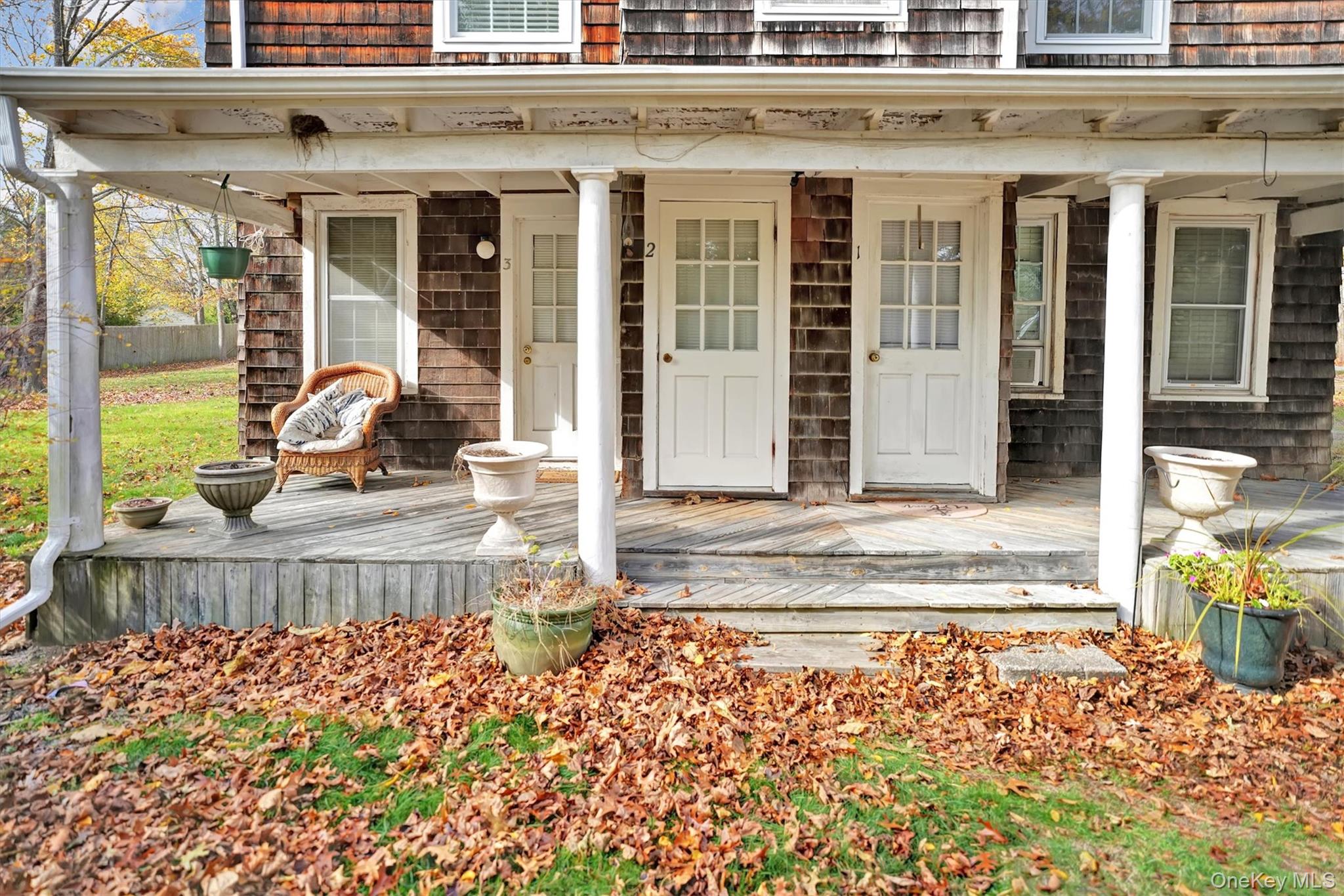 14 Halsey Avenue East Quogue, NY 11942 - Photo 2 of 23 a view of a brick building with a bench in front of house