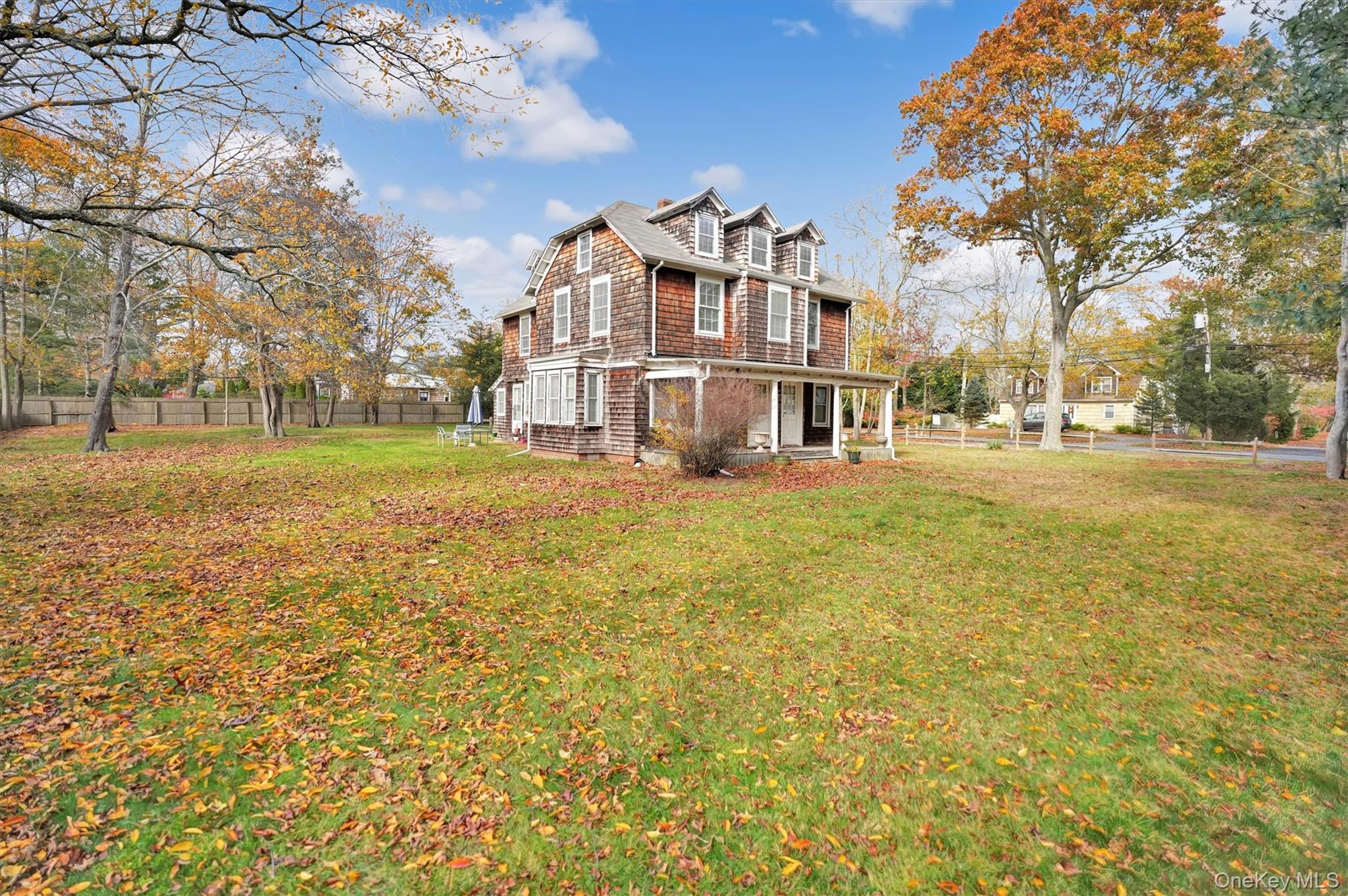 14 Halsey Avenue East Quogue, NY 11942 - Photo 6 of 23 a view of a big yard next to a building